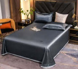 Ice Silk Bed Sheet Quilt Cover Pillowcase in Advanced Gray on a stylish bed with decorative pillows and modern decor.