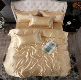Elegant gold silk bed sheet quilt cover set with decorative pillows on a stylish bed.