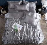 Shiny silver bed sheet quilt cover set with pillows, perfect for a cool and elegant sleeping experience.