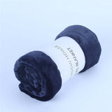 Navy blue flannel coral fleece blanket rolled up with label, perfect for air-conditioning use and napping.