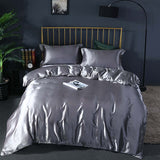 Elegant gray ice silk bed linen quilt cover with matching pillows, perfect for summer bedroom decor.