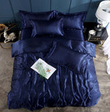 Navy blue silk bed sheet quilt cover set with pillows, ideal for a cool and elegant sleeping experience.