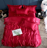 Luxurious red silk bed sheet quilt cover set for elegant sleep, includes three pieces for a stylish bedroom look.