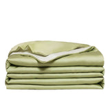 Washed Ice Silk Solid Color Silky Sleep Naked Bed Sheet Quilt Cover in soft green color, neatly stacked.