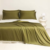 Washed Ice Silk Solid Color Silky Sleep Naked Bed Sheet and Pillowcases in olive green on a bed.