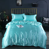 Summer Simple Pure Color Ice Silk Bed Linen Quilt Cover Bedding in teal color on a stylish gold bed frame.
