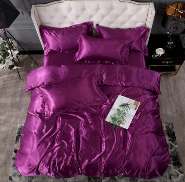 Luxurious purple silk bed sheet quilt cover set with matching pillows for a stylish bedroom decor.