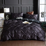 European style washed silk three-piece solid color bed sheet duvet cover in dark fabric with decorative pillows.