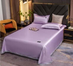 Ice silk bed sheets and pillowcases in light purple color, showcasing a cool feeling design in a modern bedroom setting.