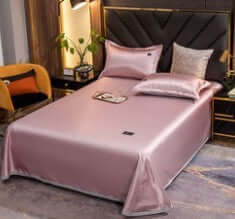 Ice Silk Bed Sheet Quilt Cover Pillowcase set in soft pink color, enhancing a modern bedroom decor with a cool feeling.