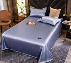 Cool feeling Ice Silk bed sheet, quilt cover, and pillowcase in Bentley Blue color. Elegant three-piece solid design.