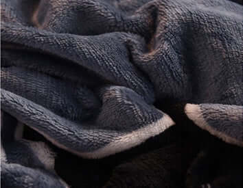 Close-up of Winter Thick Coral Fleece fabric, showcasing softness and texture for a cozy bedding experience.