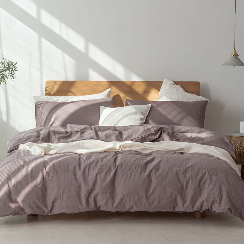 Japanese Style Muji-style bed with pure color lattice duvet cover and sheets in a modern bedroom setting.