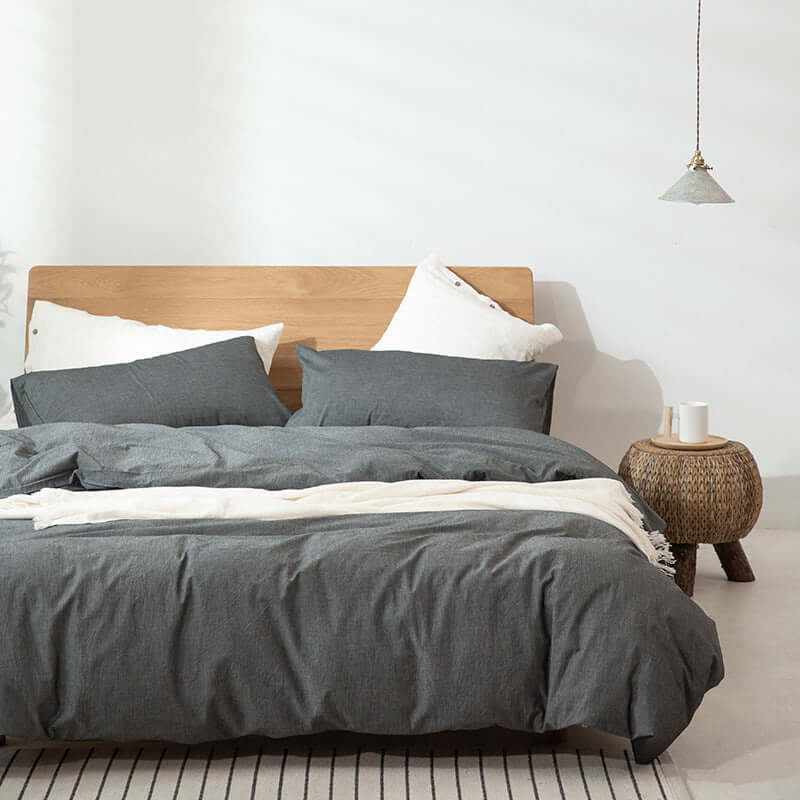 Japanese Style Muji-style bed with gray duvet cover and pillows, modern simple decor.