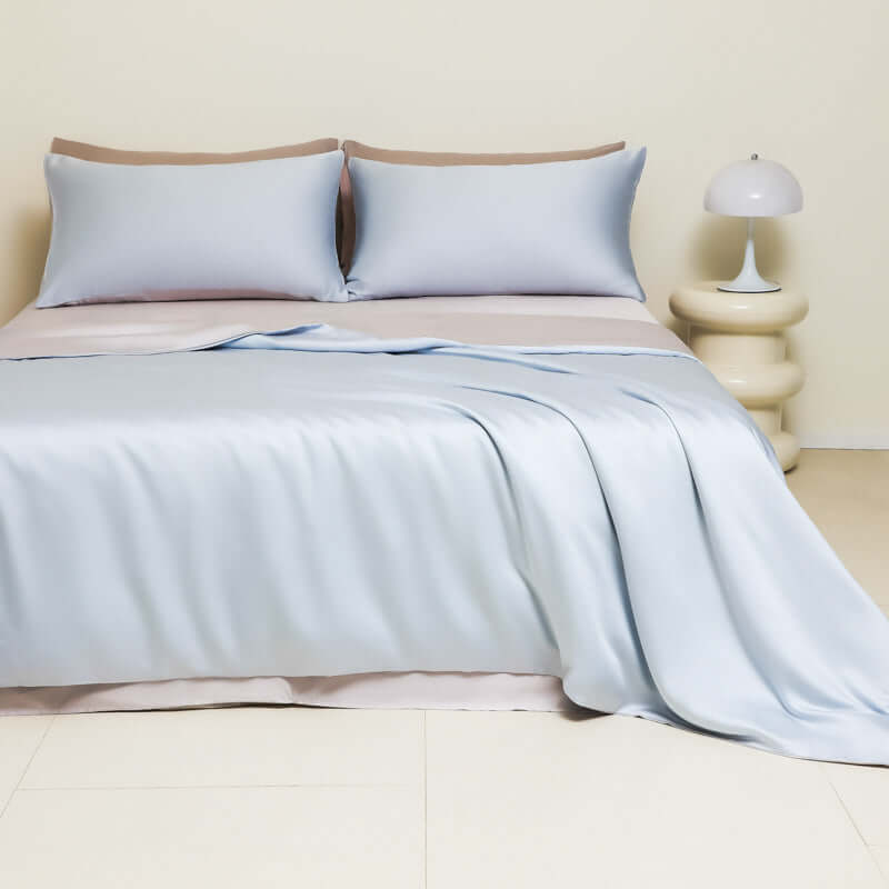 Washed ice silk solid color silky bed sheet with matching pillow covers on a stylish bed.