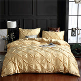 European style washed silk three-piece solid color bed sheet duvet cover in gold with decorative pillowcases.