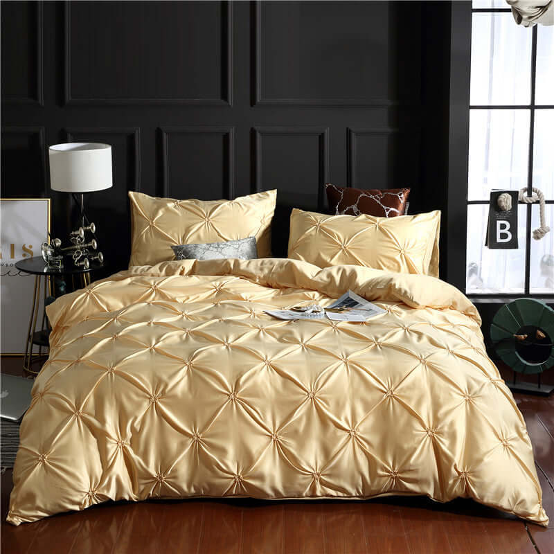 European style washed silk three-piece solid color bed sheet duvet cover in gold with decorative pillowcases.