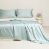 Washed Ice Silk Solid Color Silky Sleep Naked Bed Sheet Quilt Cover Fitted Sheet in light blue color on a bed.