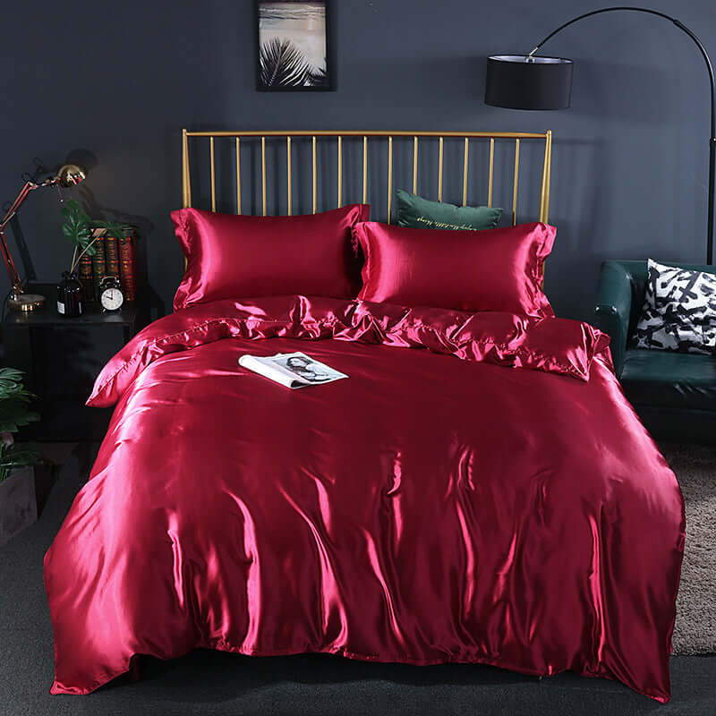 Summer Simple Pure Color Ice Silk Bed Linen Quilt Cover Bedding in luxurious red with matching pillows on a stylish bed.