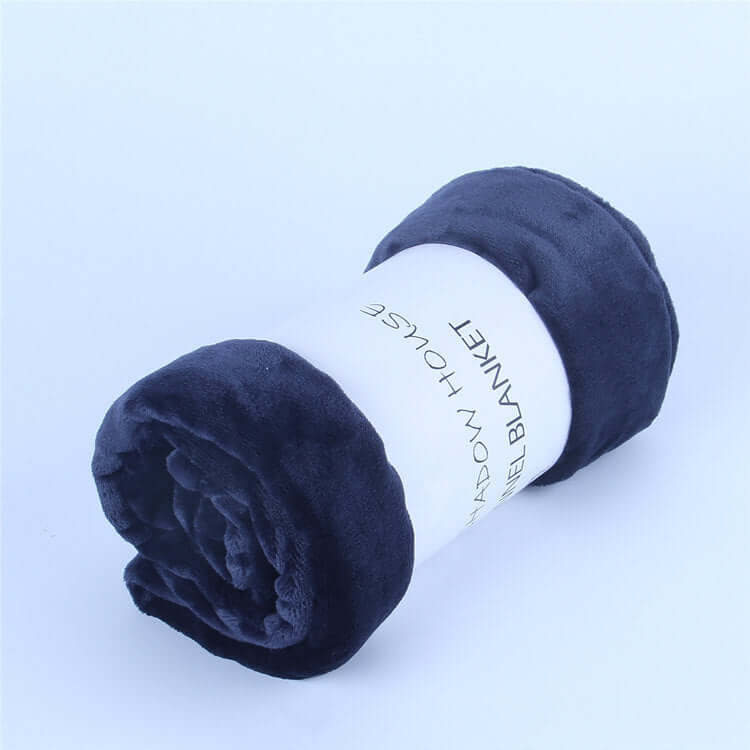 Navy blue flannel coral fleece blanket rolled up with label, perfect for air-conditioning use and napping.