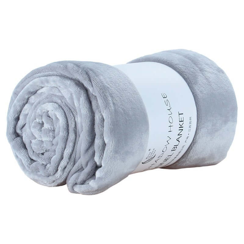 Rolled light gray flannel coral fleece blanket, soft nap blanket for air conditioning and cozy comfort.