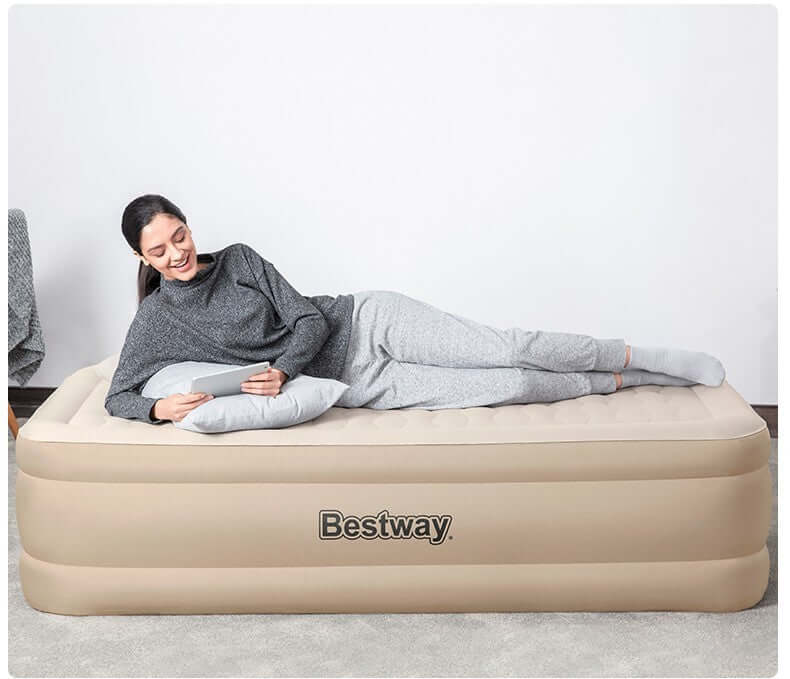 Woman relaxing on a Bestway single double layer floatation bed with cloth cover.
