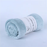 Soft flannel blanket rolled up in light blue, perfect for cozy warmth and air-conditioning use.