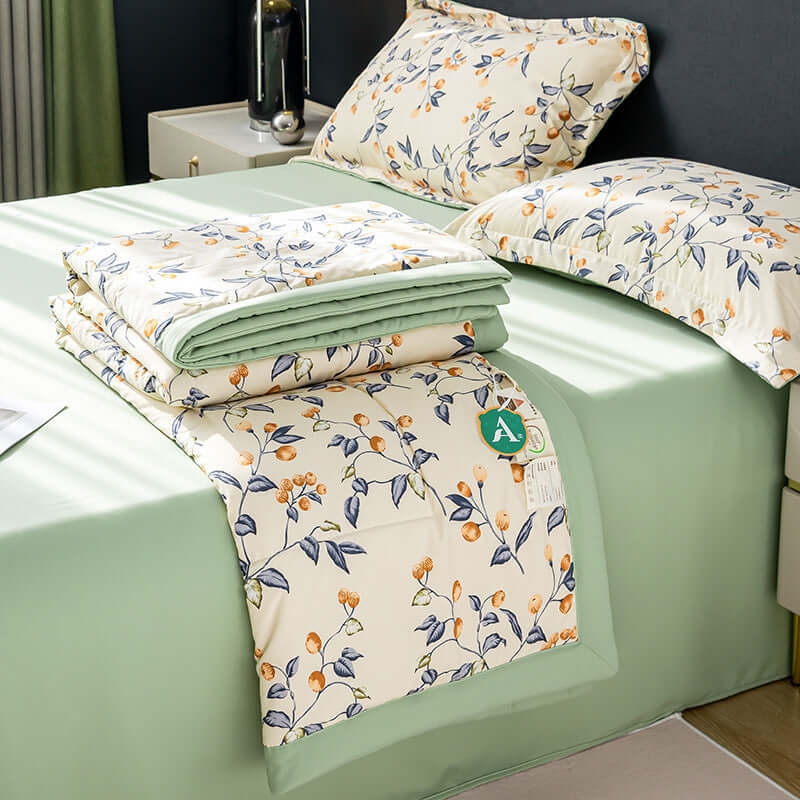 Cotton and linen double-layer summer blanket and pillowcases on a green bedspread, modern four-piece bedding set.
