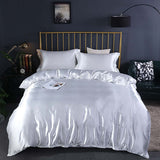Summer Simple Pure Color Ice Silk Bed Linen Quilt Cover Bedding in elegant silver color with matching pillows.